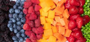plate of marion blackberries, blueberries, diced butternut squash, diced sweet potato, strawberries and green pas arranged by color