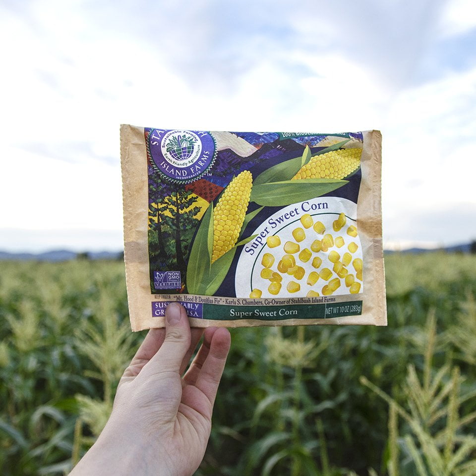Bag of Stahlbush Island Farms Super Sweet Corn in a field Bag of Stahlbush Island Farms Sustainable Farming Super Sweet Corn in a field