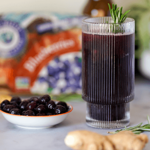 sparkling blueberry ginger mocktail in a cocktail glass