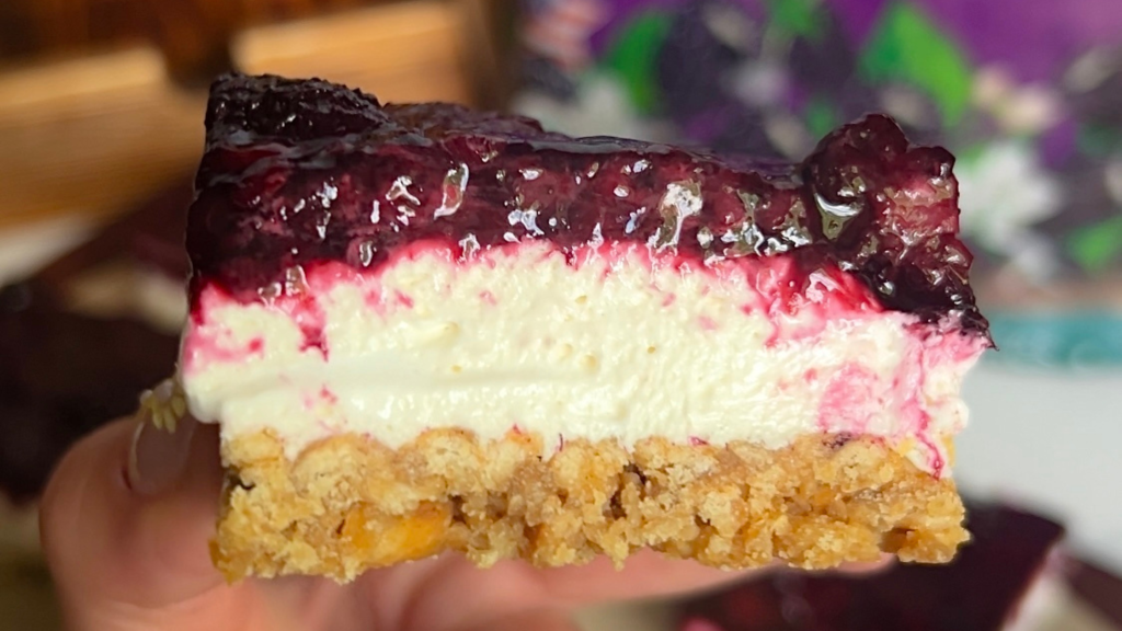 a close up shot of a blackberry pretzel salad bar
