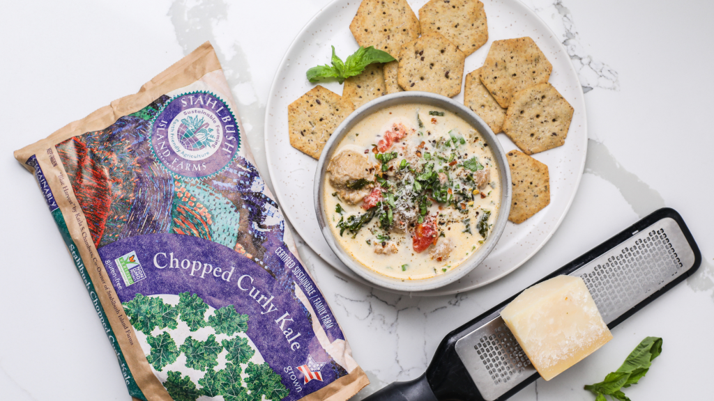 a bowl of soup with a bag of Stahlbush Island Farms Frozen Curly Kale