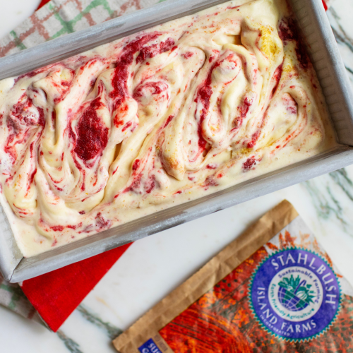 a container of strawberry cheesecake ice cream and a bag of Stahlbush Island Farms strawberries