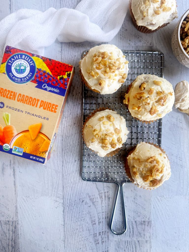 a spread of carrot cake muffins and a box of Stahlbush Island Farms Frozen Organic Carrot Puree Triangles