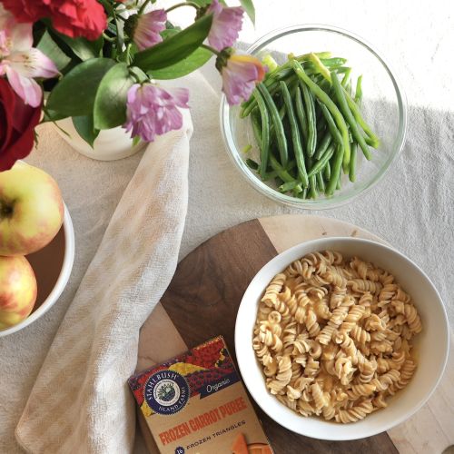 a bowl of pasta and a box of Stahlbush Island Farms Frozen Organic Carrot Puree Triangles