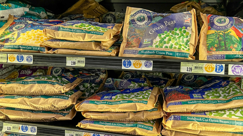 a display of bags of frozen vegetables in the freezer section at the grocery store of Stahlbush Island Farms' products