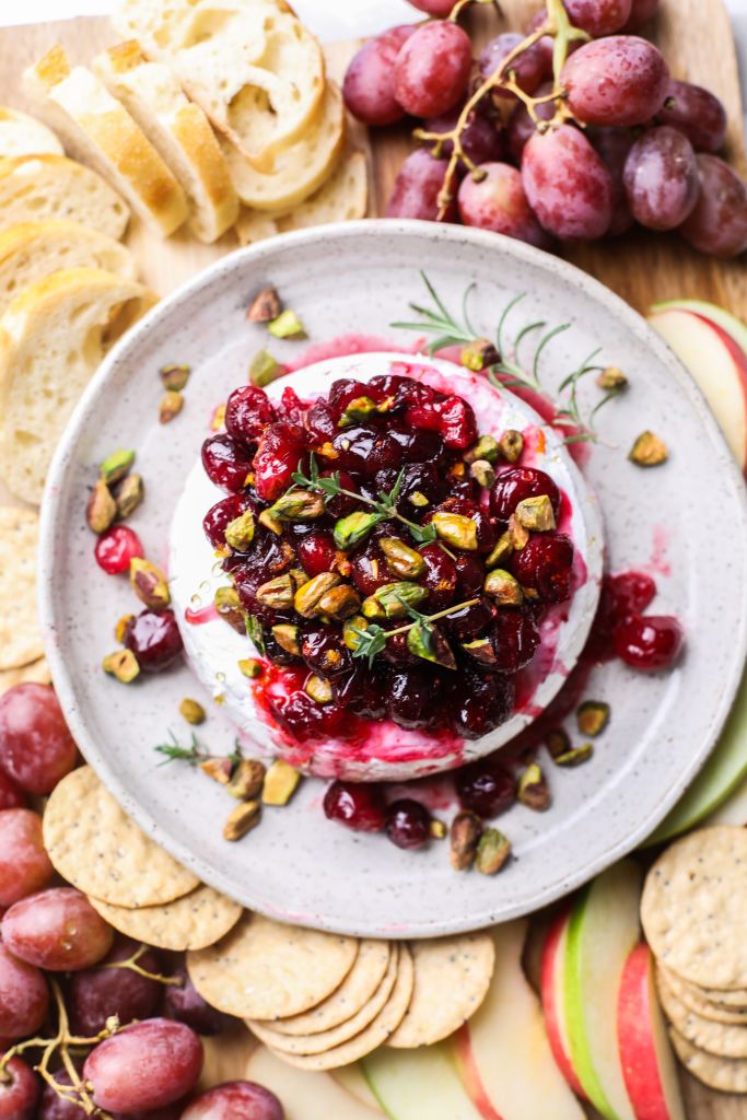 a whole baked brie with cranberry compote on top