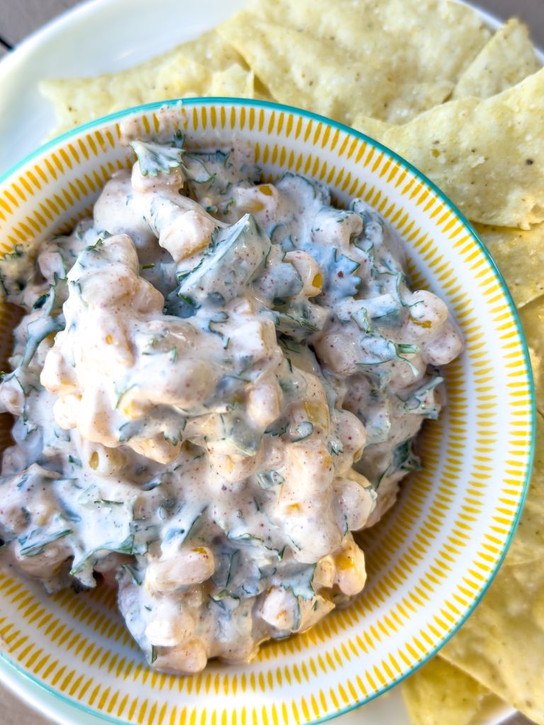 a bowl of street corn dip made with Stahlbush Island Farms' Frozen Super Sweet Corn