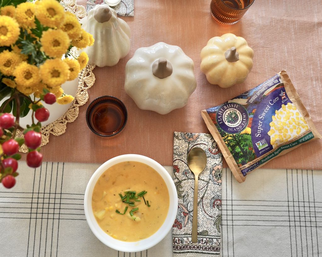 a bowl of corn chowder with a bag of Stahlbush Island Farms Frozen Super Sweet Corn