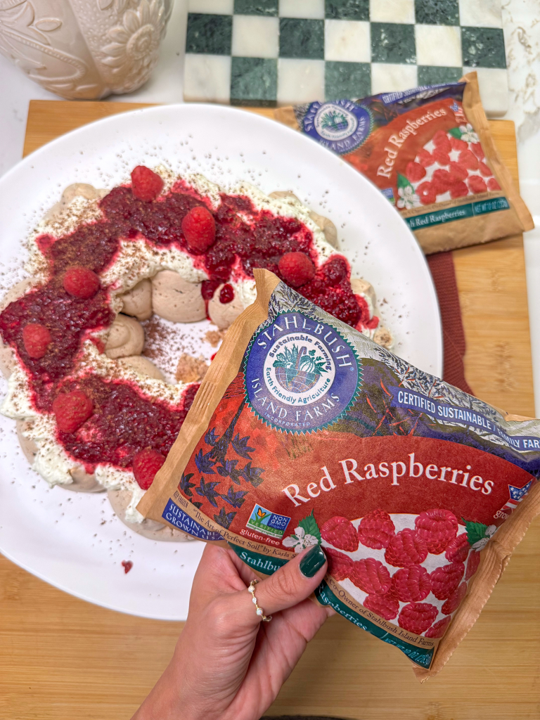 a chocolate pavlova wreath with raspberry jam with a bag of Stahlbush Island Farms Frozen Raspberries