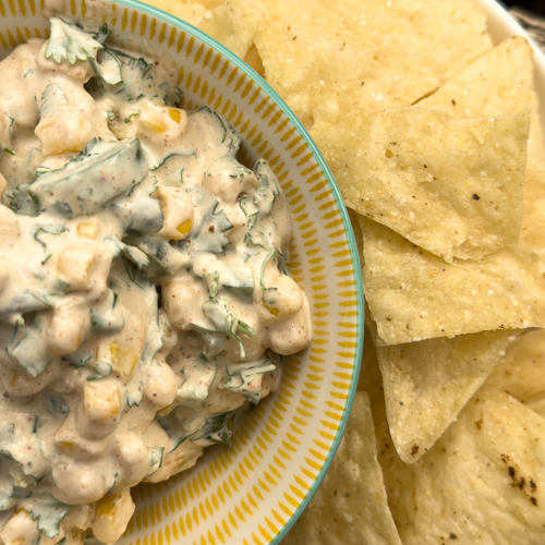 a bowl of street corn dip made with Stahlbush Island Farms' Frozen Super Sweet Corn